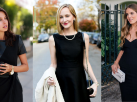 Three women in black dresses pose outdoors. The first adjusts her hair, the second holds a white coat, and the third touches an earring while holding a clutch. Their elegant black dresses stand out amidst blurred greenery and urban buildings behind them.