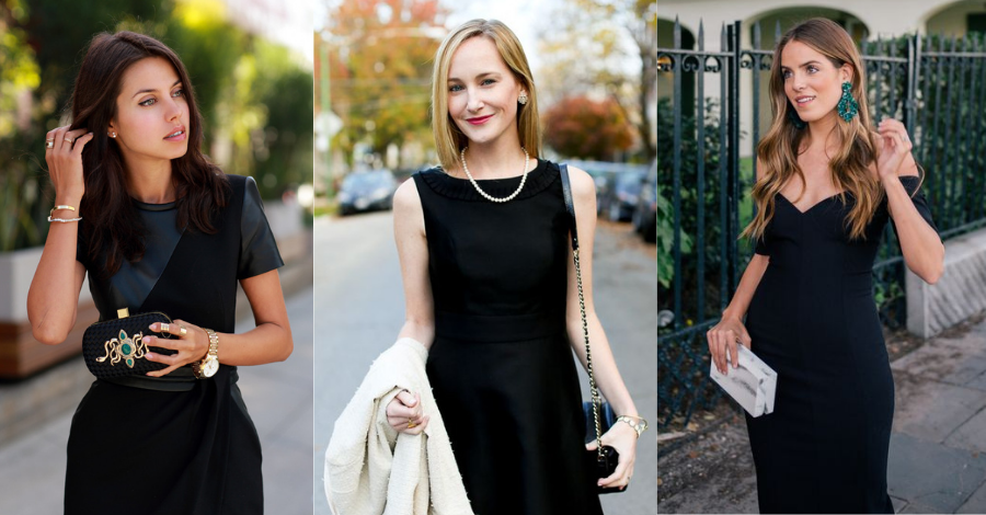 Three women in black dresses pose outdoors. The first adjusts her hair, the second holds a white coat, and the third touches an earring while holding a clutch. Their elegant black dresses stand out amidst blurred greenery and urban buildings behind them.
