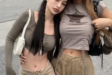 Two Asian women in khaki pants and crop tops embody the Acubi Aesthetic, showcasing a stylish and modern look.
