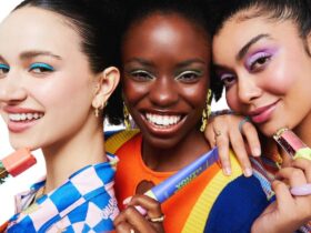 Three joyful women display their makeup brushes, showcasing the spirit of women-owned beauty brands.