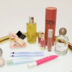 A gold tray displaying an assortment of beauty products and cosmetics, elegantly arranged for a luxurious appearance.