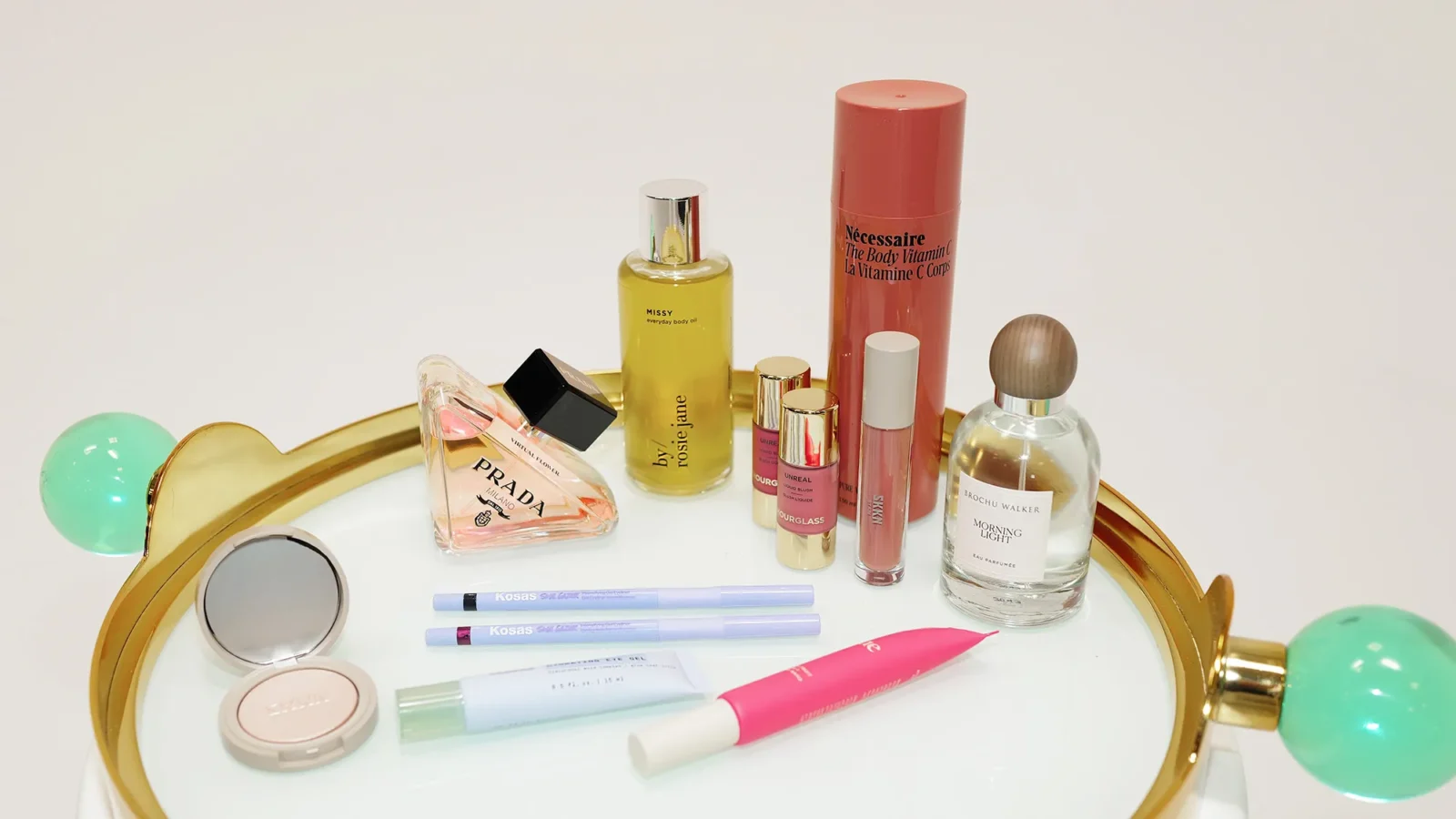 A gold tray displaying an assortment of beauty products and cosmetics, elegantly arranged for a luxurious appearance.