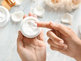 Person applying cream from a jar, showing why people avoid silicone in skin care.